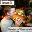 person attempting to eat a giant burger that is twice the size of their head