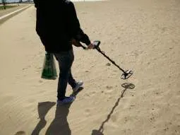 Metal Detector on a beach looking for treasure