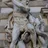 close up of hercules and the hydra sculpture carved on the building facade