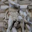 close up of hercules and the hydra sculpture carved on the building facade