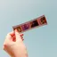 a person holding a photo film negative