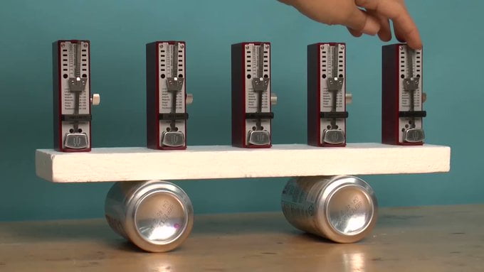 Out of sync metronomes slowly synchronise spontaneously