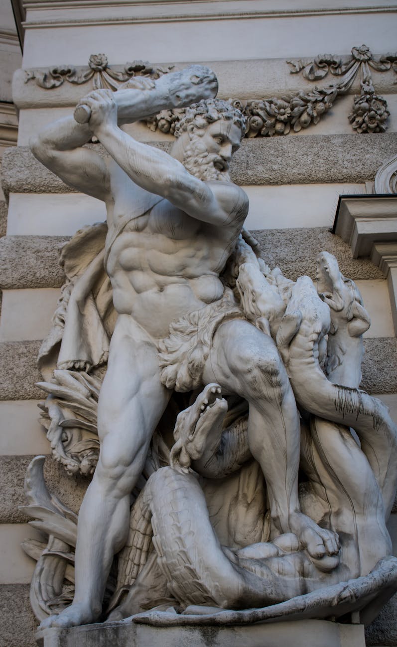 close up of hercules and the hydra sculpture carved on the building facade