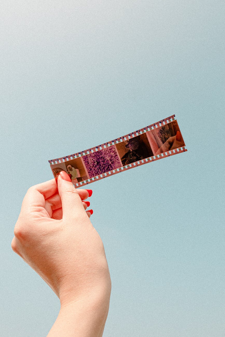 a person holding a photo film negative